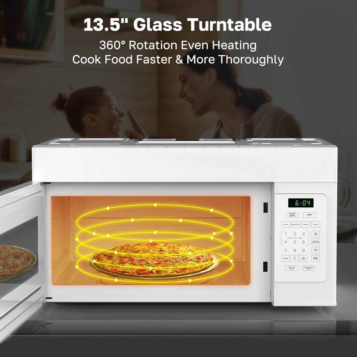 White microwave oven with glass turntable showing pizza inside, on a blurred kitchen background.